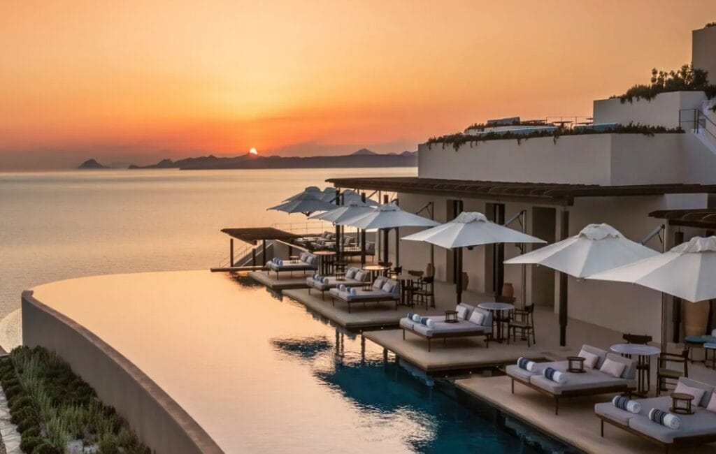 Terrace of One&Only Kéa Island at sunset, overlooking the Aegean Sea with a warm, golden glow.