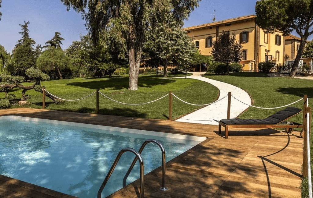 BoMa Country House surrounded by the lush greenery of Tenuta Naturale della Marcigliana in Rome.