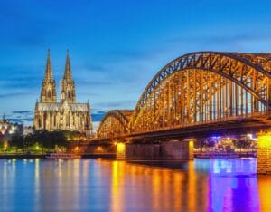 LGBTQ flags in Cologne, Germany, welcoming American LGBTQ travelers with open arms.