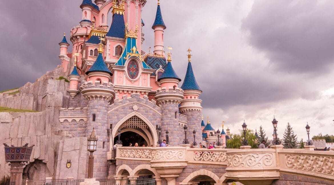 Sleeping Beauty Castle at Disneyland Paris during sunset.