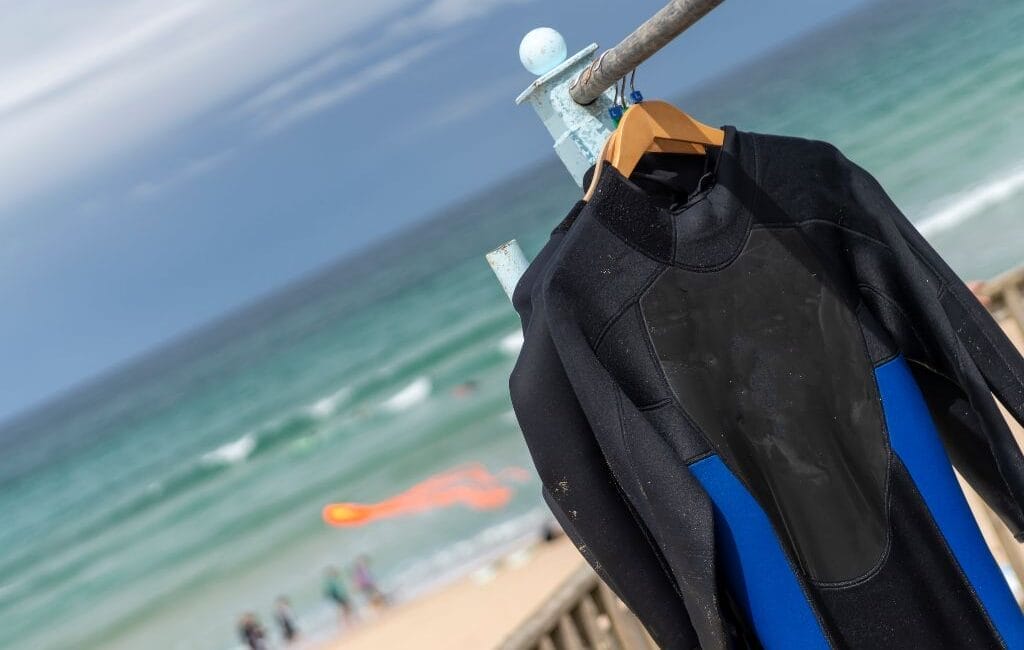 Surfer catching a wave at sunset at Fistral Beach, showcasing Cornwall's premier surf destination