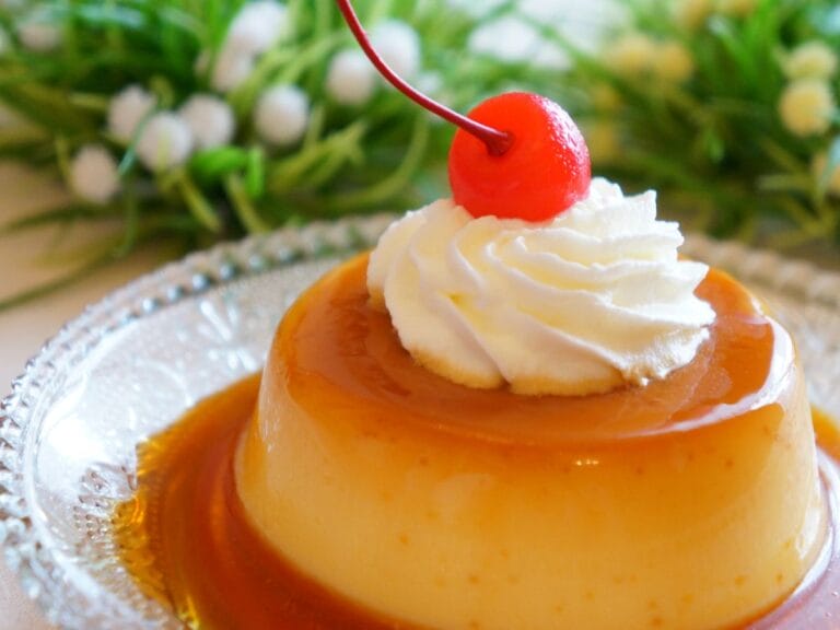 Homemade flan with caramel topping on a white plate