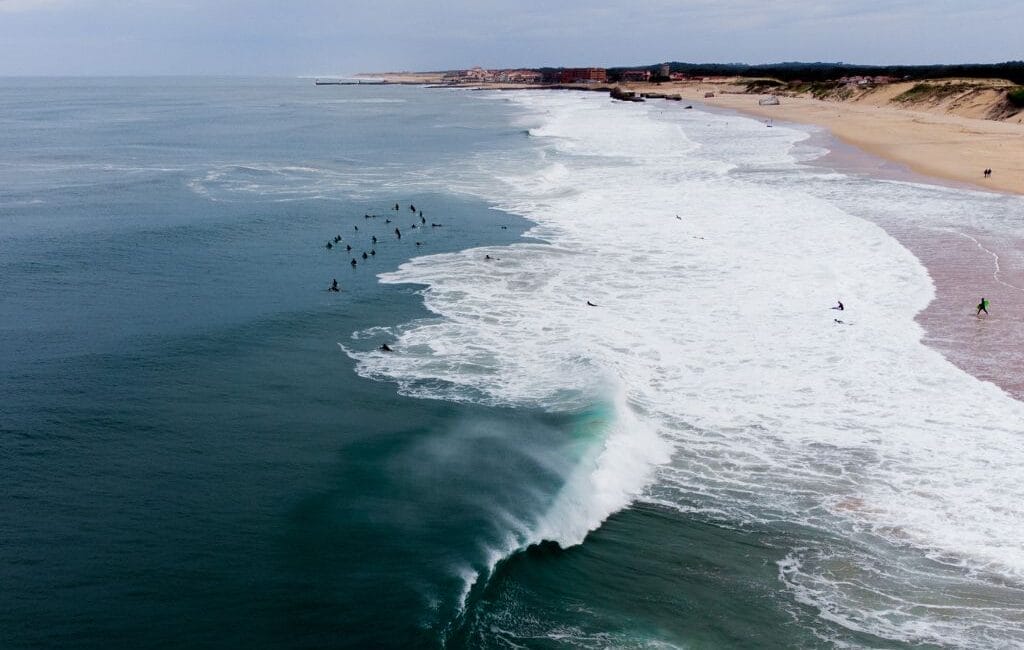 A surfer catching a powerful wave at La Gravière, Hossegor, highlighting the thrill of surfing in Europe's surf capital