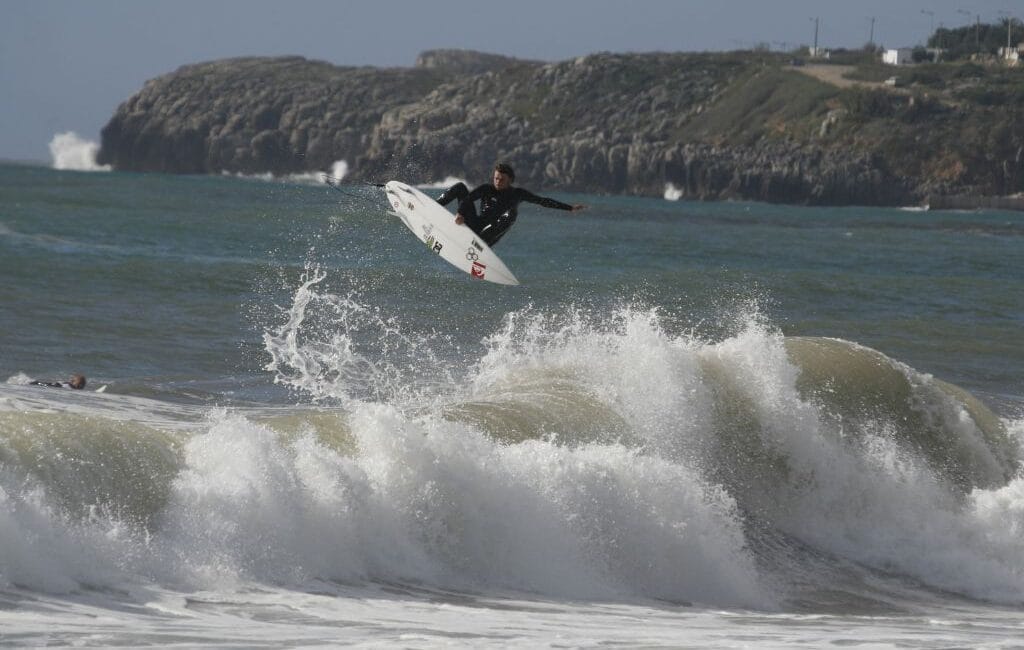 Surfer riding a perfect barrel at Supertubos, Peniche, Portugal's surf capital.