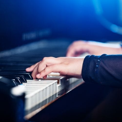 Hands of a pianist playing the piano.