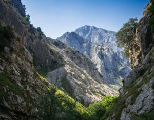 Panoramic view of the Picos de Europa mountain range with towering limestone peaks and lush green valleys