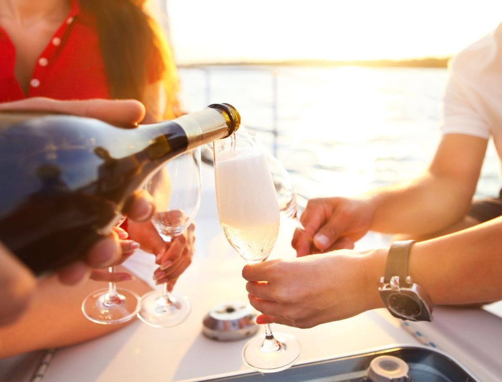 Wine tasting onboard a Rhine River cruise, with someone pouring wine into glasses.