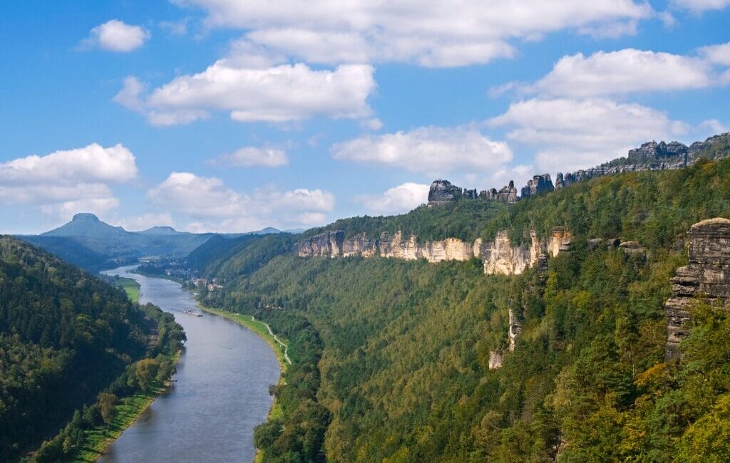 Panoramic view of Saxon Switzerland with towering sandstone cliffs and lush green valleys