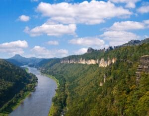 Panoramic view of Saxon Switzerland with towering sandstone cliffs and lush green valleys