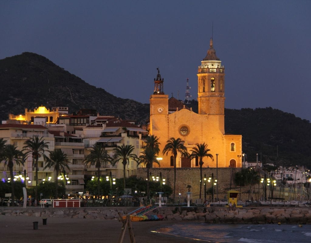 LGBTQ visitors enjoying the vibrant atmosphere and beautiful beaches of Sitges, a premier European LGBTQ destination.