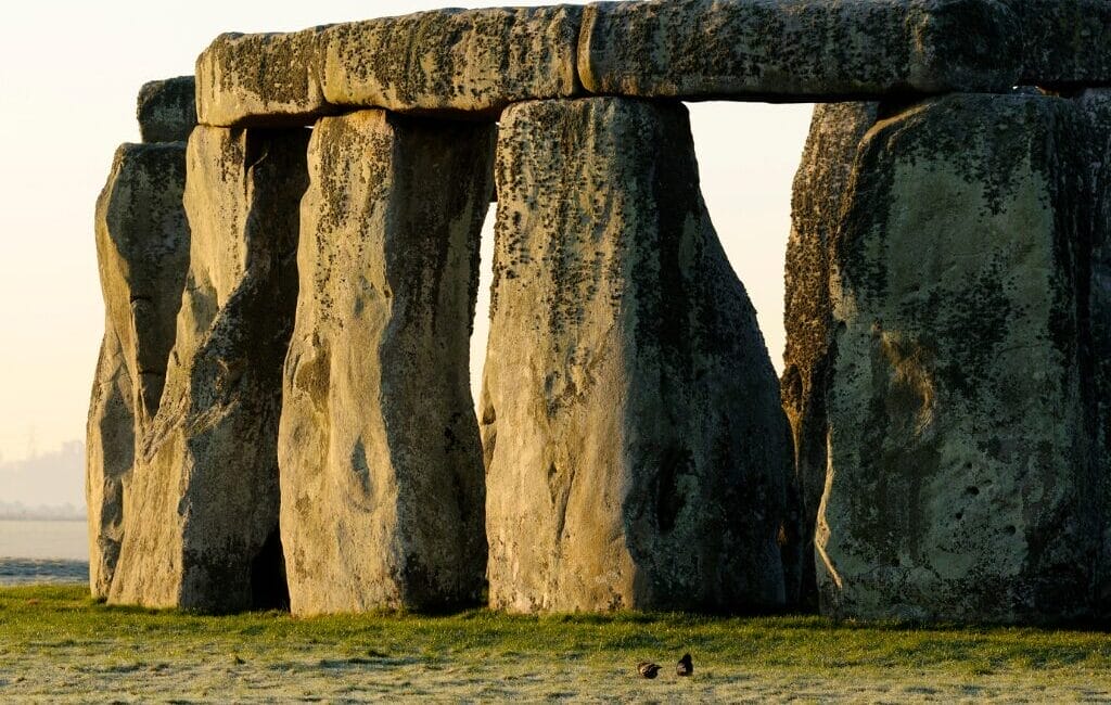 Stonehenge stone circle with massive sarsen stones set against a grassy