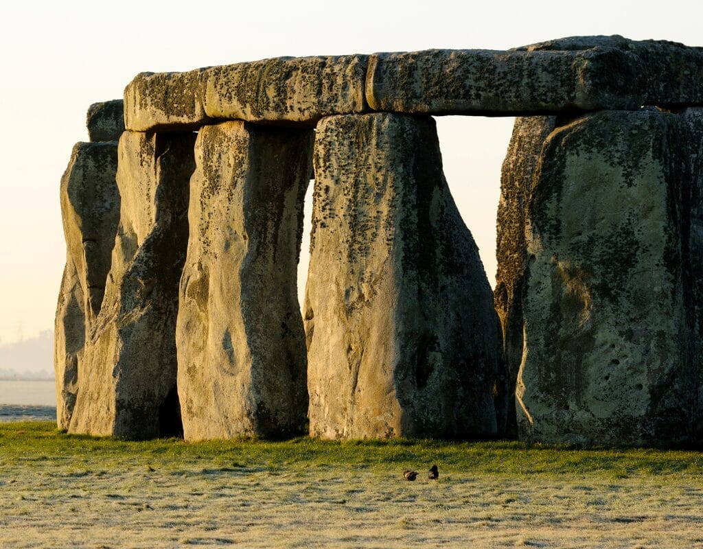 Stonehenge stone circle with massive sarsen stones set against a grassy