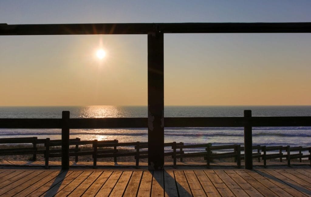 Surfers catching waves at sunset in Vieux Boucau, France's picturesque surf paradise