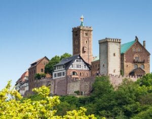 Wartburg Castle on a hill under a bright blue sky