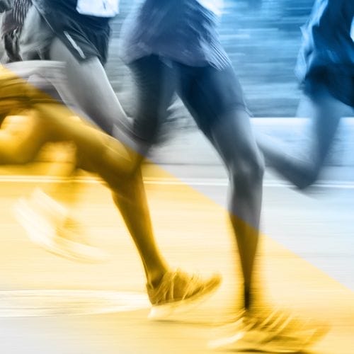 Running legs of marathon participants in Berlin.