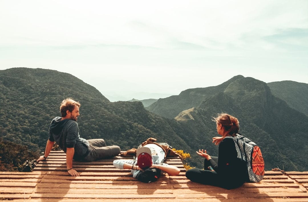 Three young people taking a break during a hike