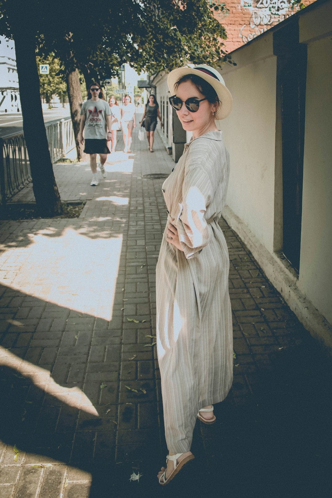 A young woman wearing sunglasses in an Italian city, illustrating personal space.