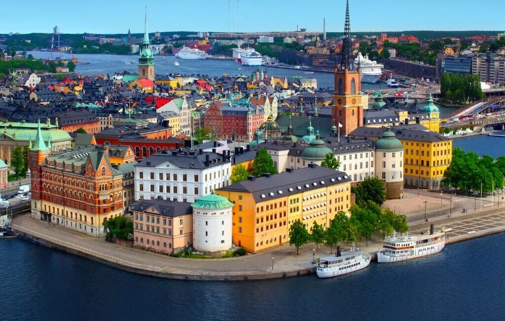 Stockholm skyline at dusk with iconic bridge and city lights, reflecting Sweden's cultural diversity