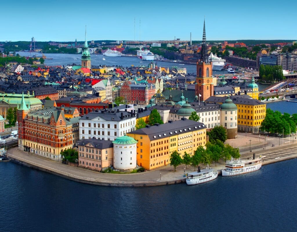 Stockholm skyline at dusk with iconic bridge and city lights, reflecting Sweden's cultural diversity