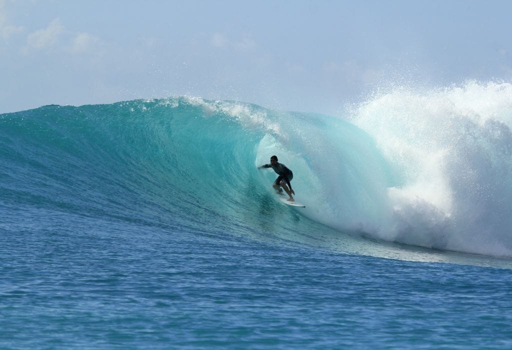 Surfer riding a massive wave, showcasing the power of Europe's top surf beaches.